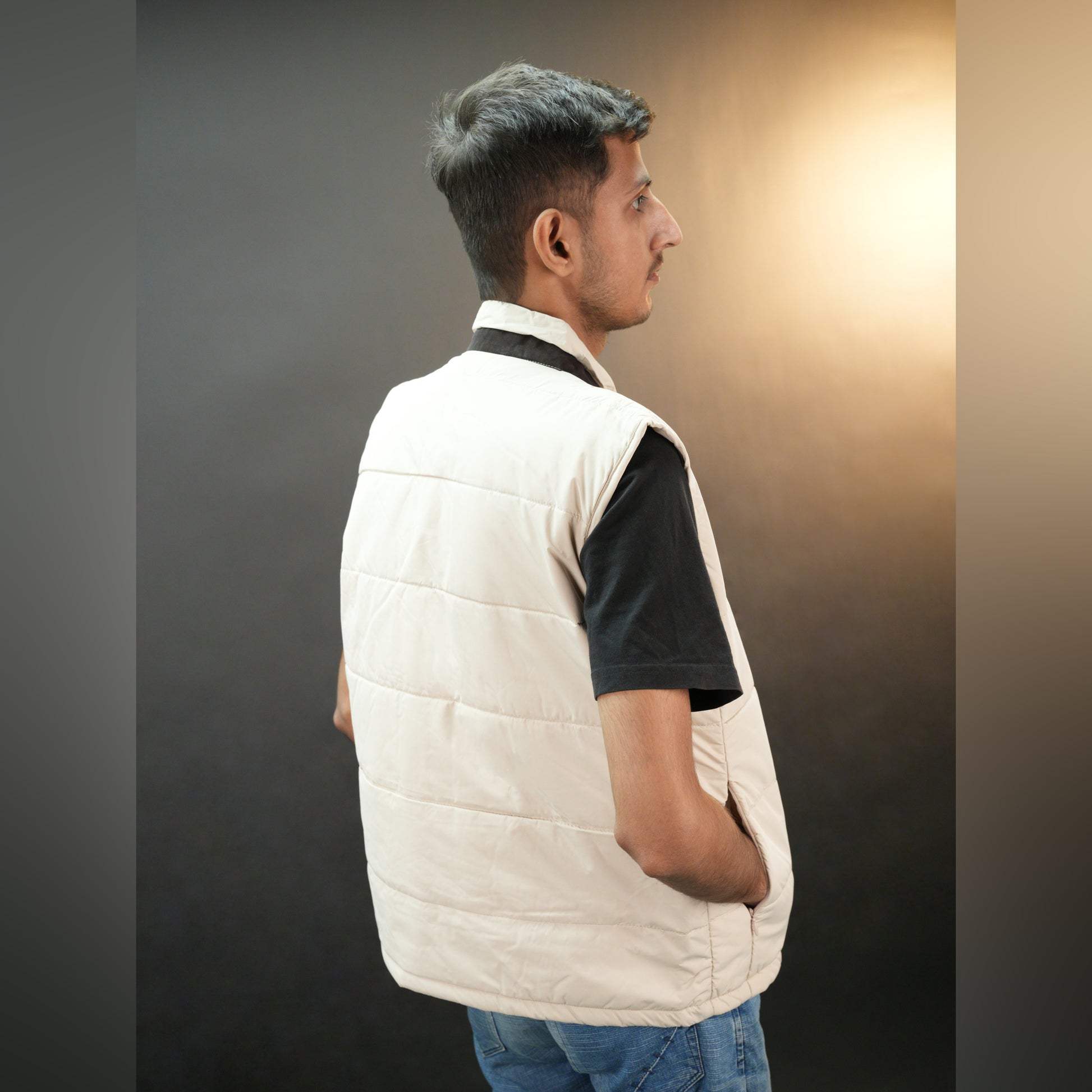 Teen beige and grey puffer vest with button closure, two side snap pockets, one inner pocket, lightweight and warm for winter