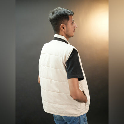 Teen beige and grey puffer vest with button closure, two side snap pockets, one inner pocket, lightweight and warm for winter