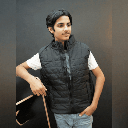 Teen lightweight puffer vest in blue and black with full zip, side snap pockets, and inner pockets—warm and ideal for winter