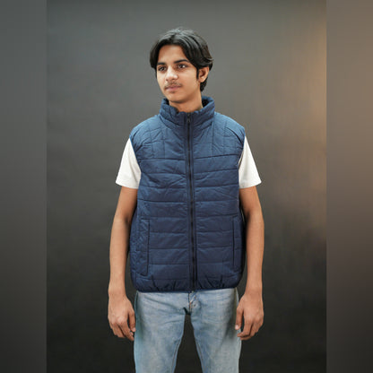 Teen lightweight puffer vest in blue and black with full front zip, two side snap pockets, and two inside pockets, warm and ideal for winter