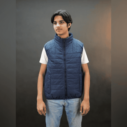 Teen lightweight puffer vest in blue and black with full front zip, two side snap pockets, and two inside pockets, warm and ideal for winter