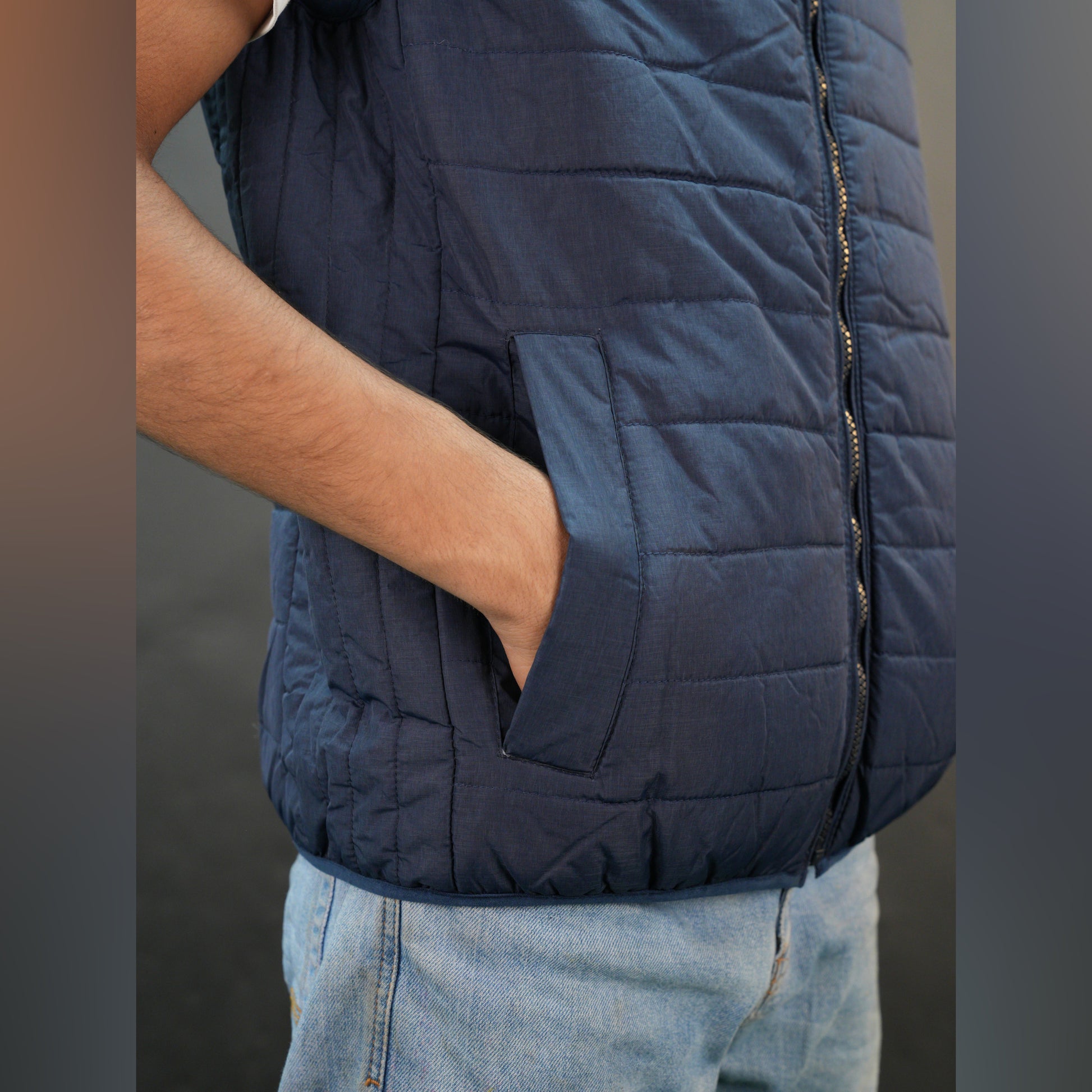 Teen lightweight puffer vest in blue and black with full front zip, two side snap pockets, and two inside pockets, warm and ideal for winter