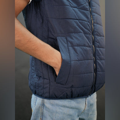 Teen lightweight puffer vest in blue and black with full front zip, two side snap pockets, and two inside pockets, warm and ideal for winter