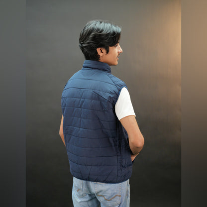 Teen lightweight puffer vest in blue and black with full front zip, two side snap pockets, and two inside pockets, warm and ideal for winter