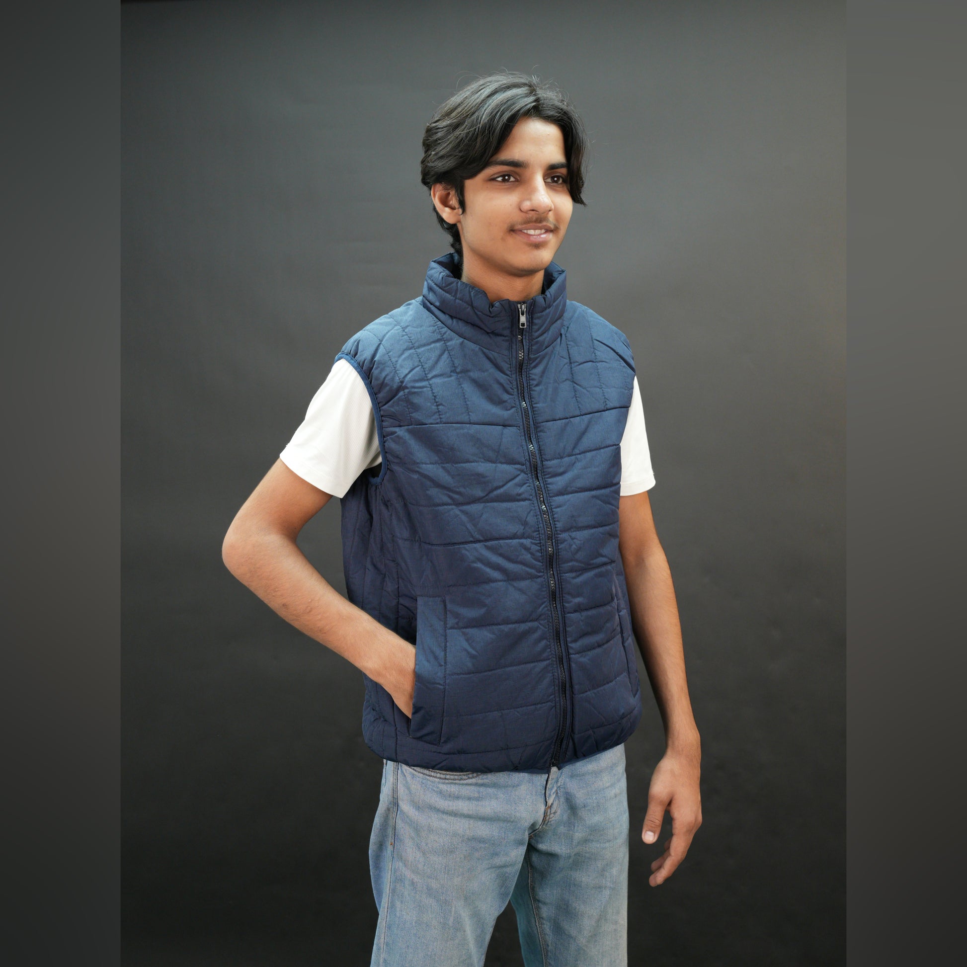 Teen lightweight puffer vest in blue and black with full front zip, two side snap pockets, and two inside pockets, warm and ideal for winter