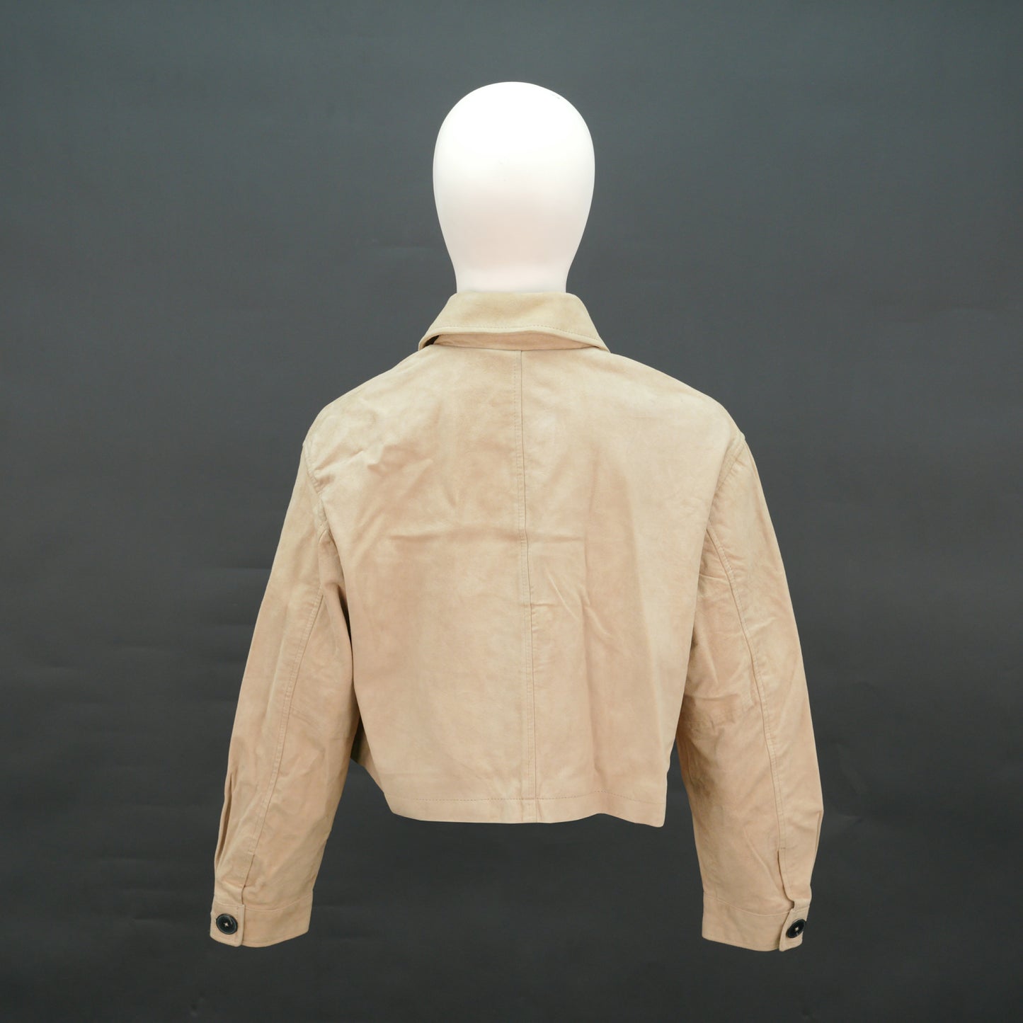 Beige suede cropped jacket with shirt collar, front pockets, and slim fit design.