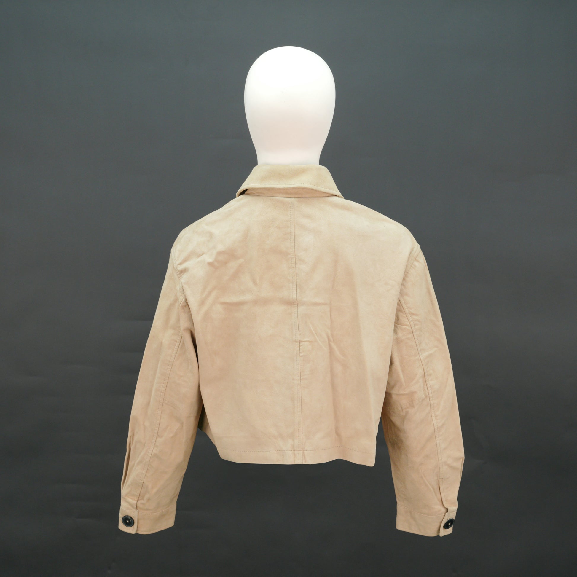 Beige suede cropped jacket with shirt collar, front pockets, and slim fit design.