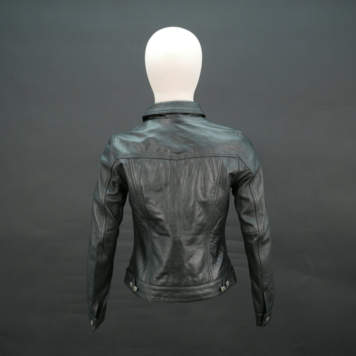 Black cropped leather jacket with shirt collar, flap pockets, and slim fit design.