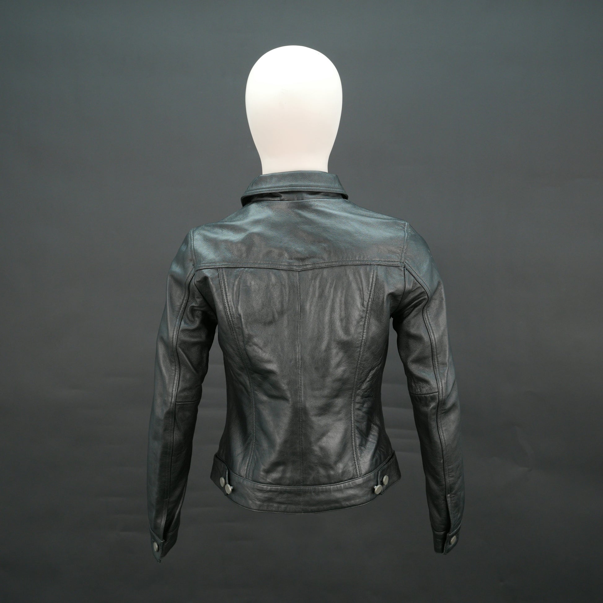 Black cropped leather jacket with shirt collar, flap pockets, and slim fit design.