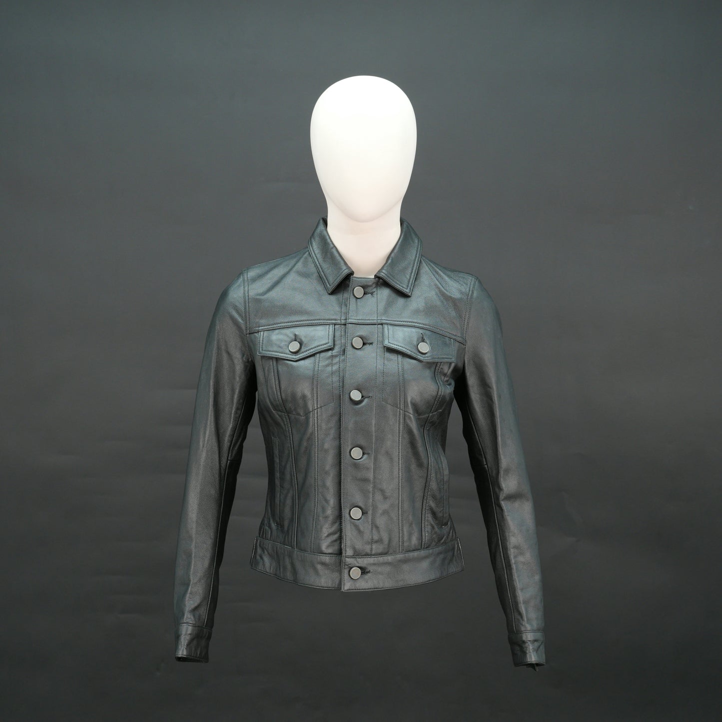 Black cropped leather jacket with shirt collar, flap pockets, and slim fit design.