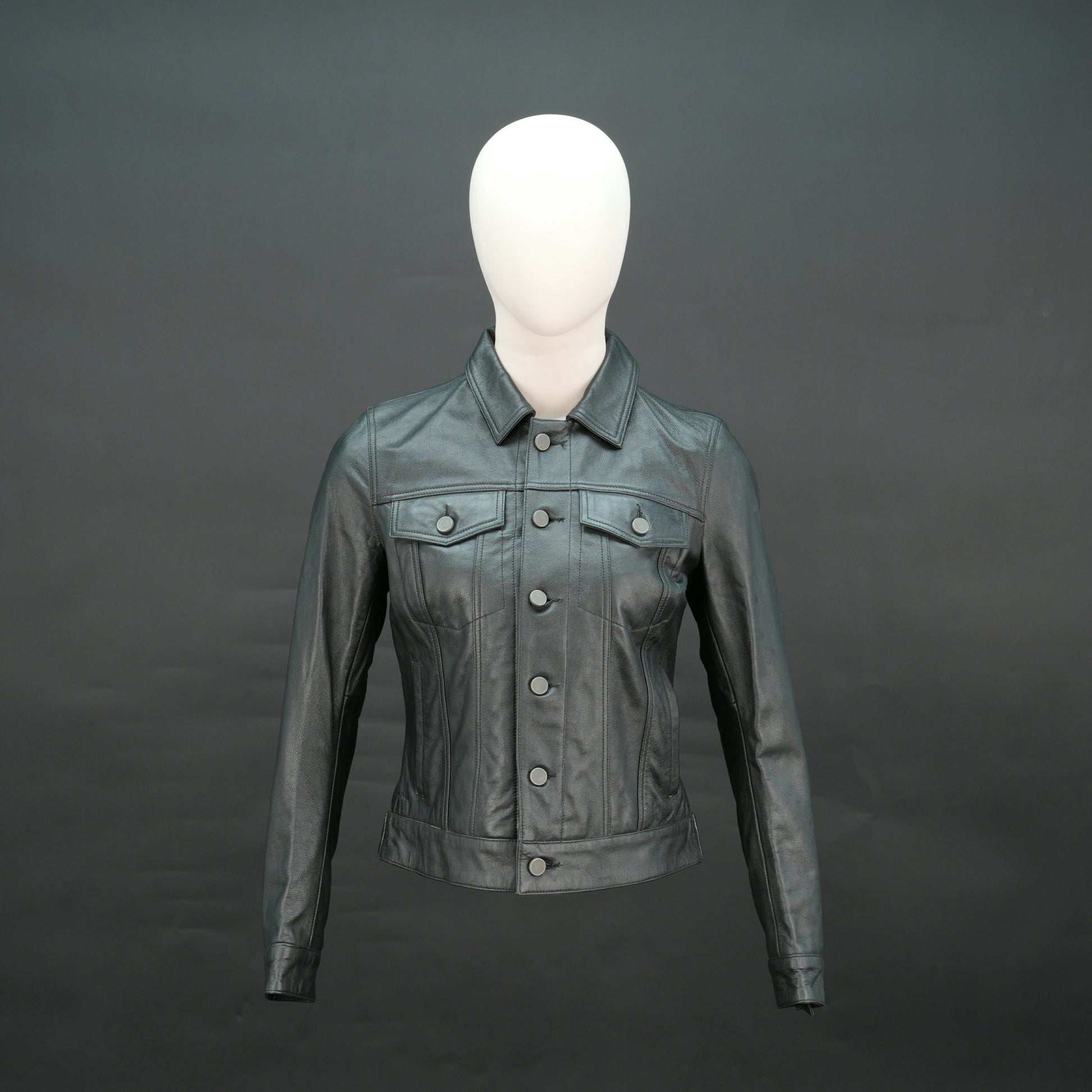 Black cropped leather jacket with shirt collar, flap pockets, and slim fit design.