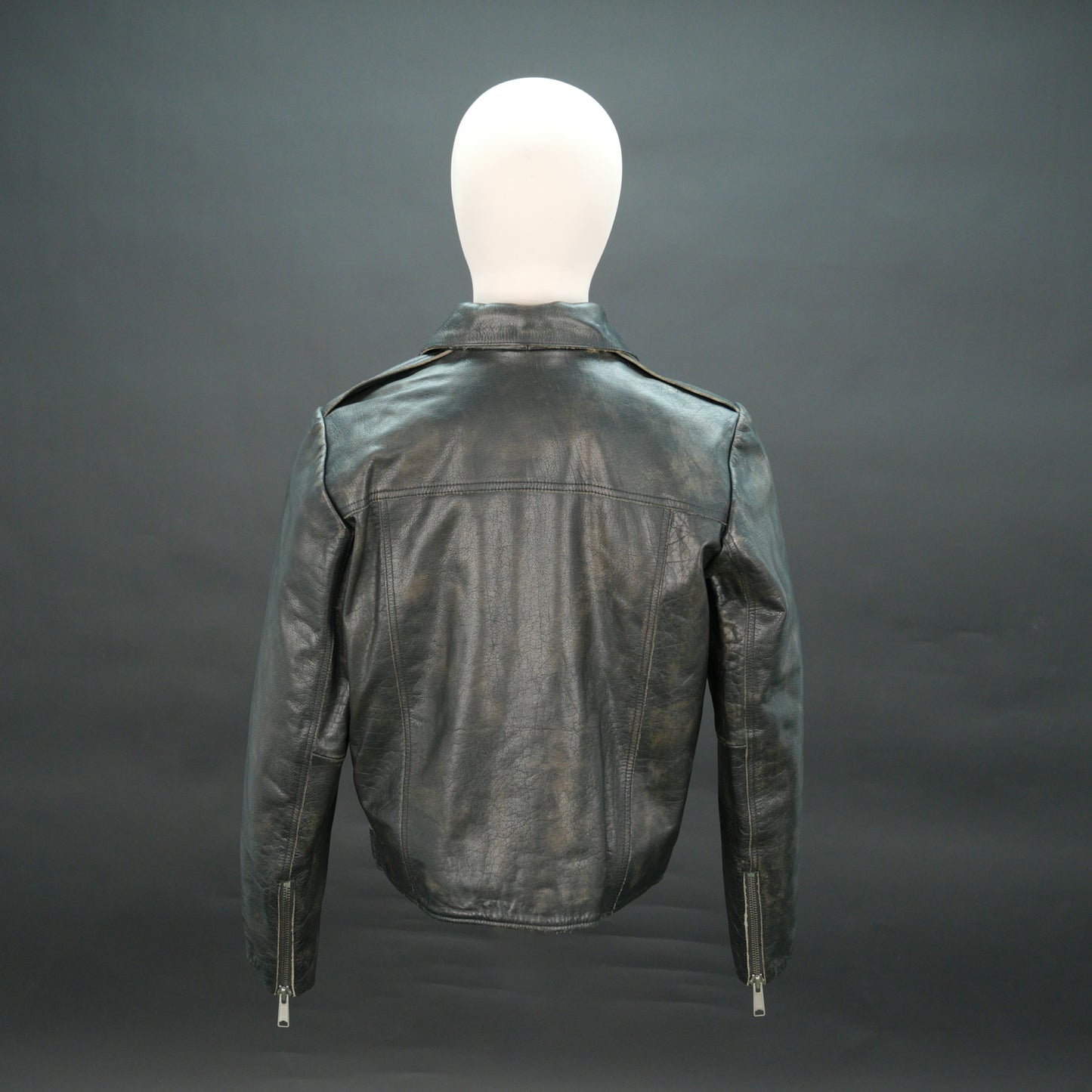 Black leather moto jacket with asymmetric zip and slim fit.