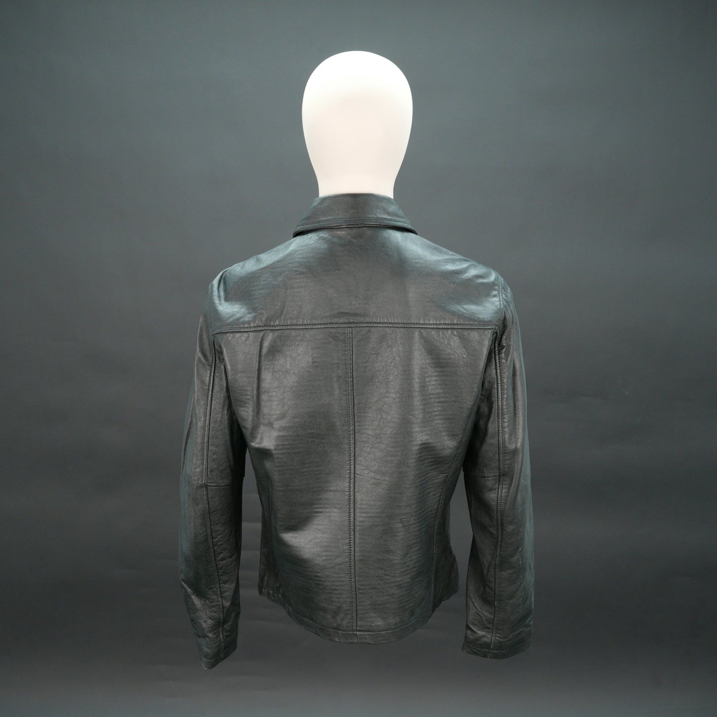 Black leather jacket with stand-up collar, zip closure, and slim fit.