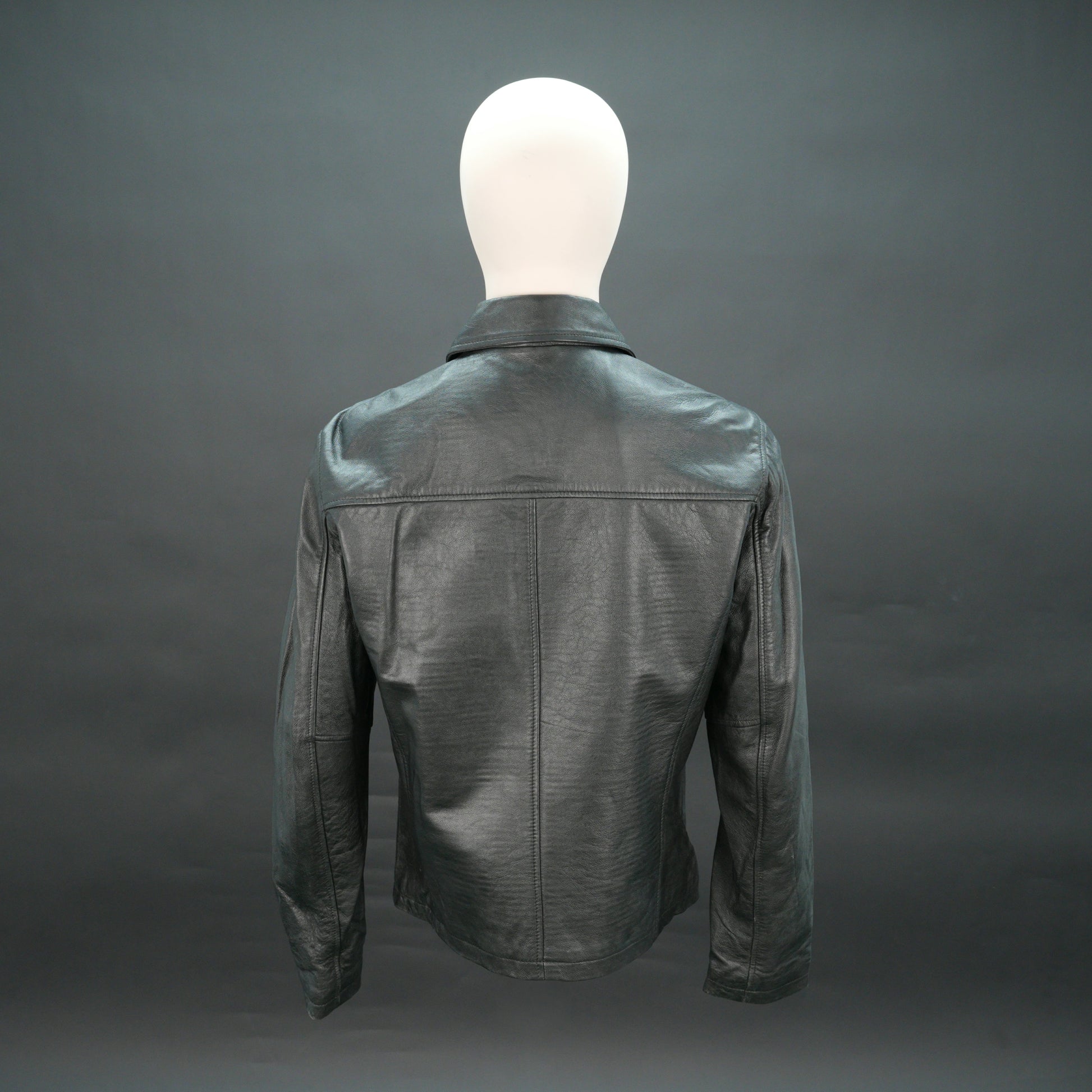Black leather jacket with stand-up collar, zip closure, and slim fit.