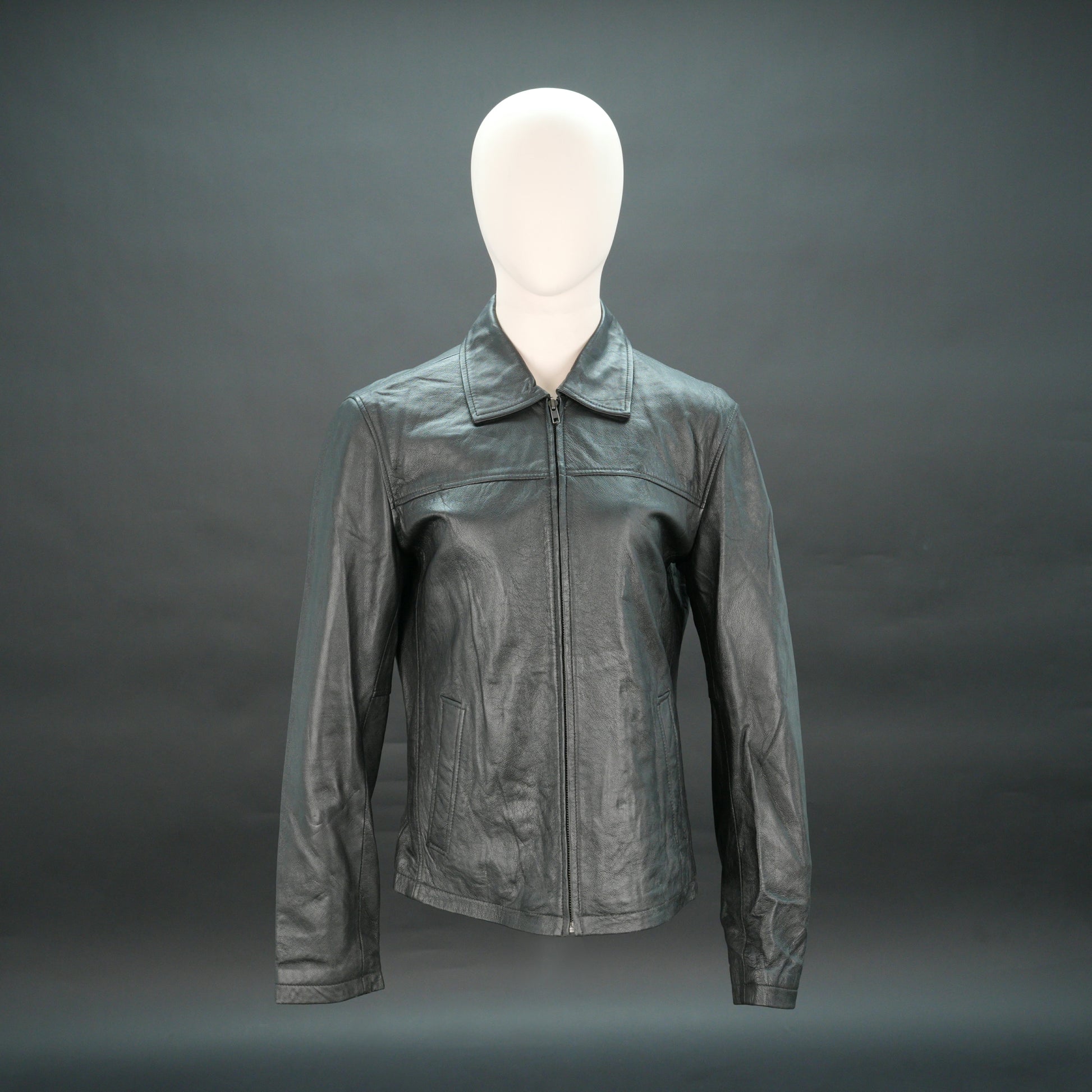 Black leather jacket with stand-up collar, zip closure, and slim fit.