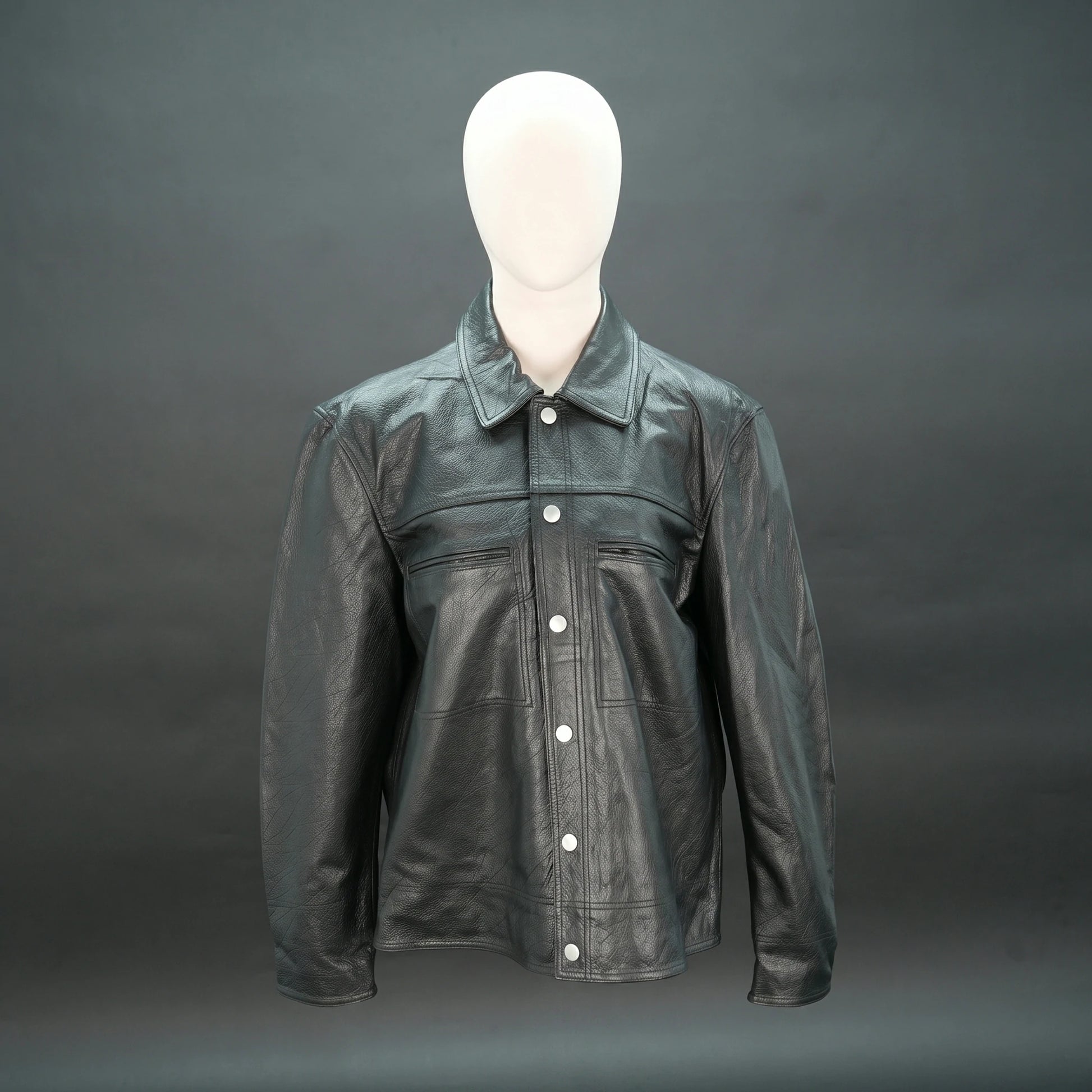 Black leather jacket with spread collar, button closure, and relaxed fit.