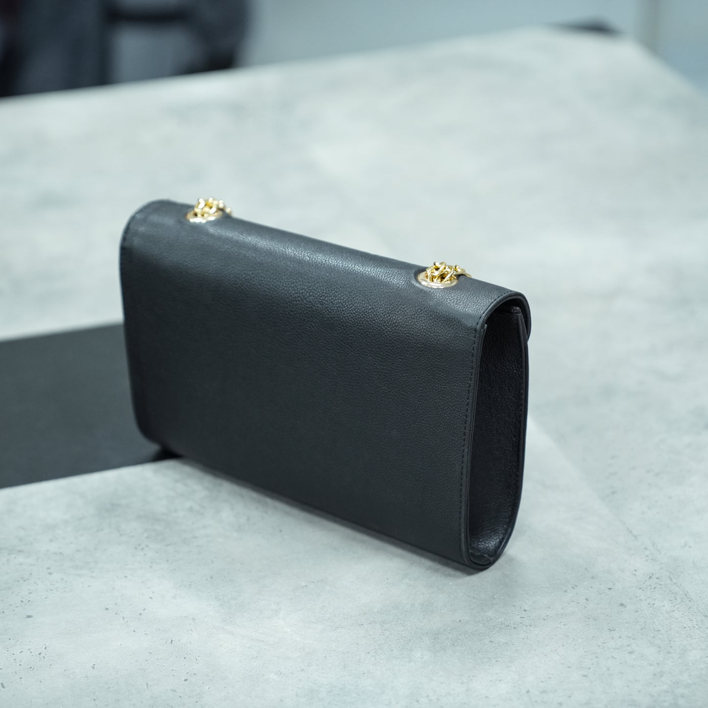 Classic black leather crossbody bag with long chain strap and two open pockets—stylish, durable, and perfect for both casual and formal occasions.