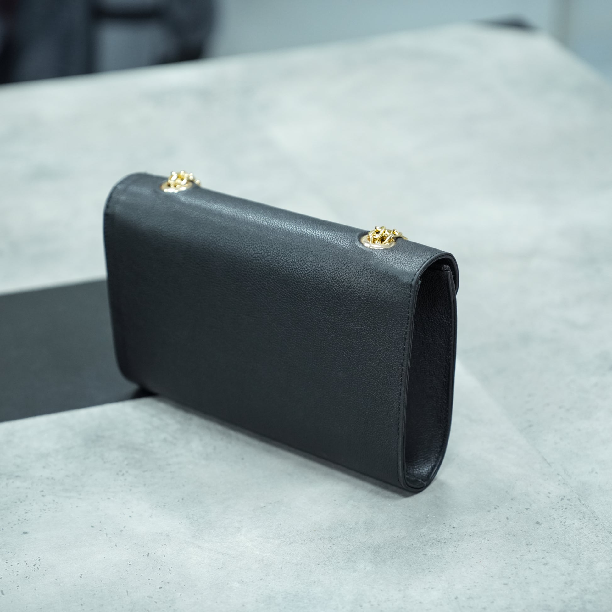 Classic black leather crossbody bag with long chain strap and two open pockets—stylish, durable, and perfect for both casual and formal occasions.