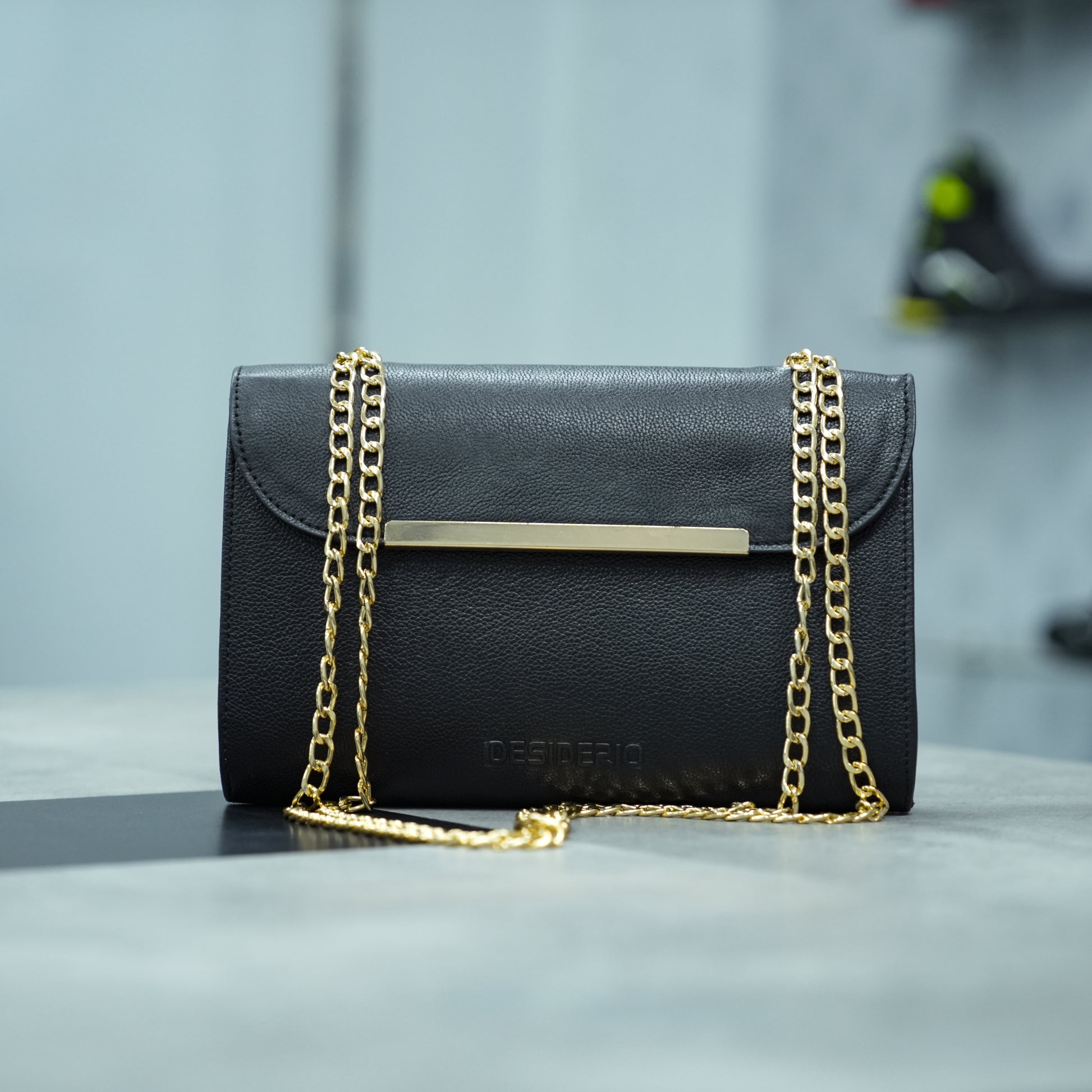 Classic black leather crossbody bag with long chain strap and two open pockets—stylish, durable, and perfect for both casual and formal occasions.