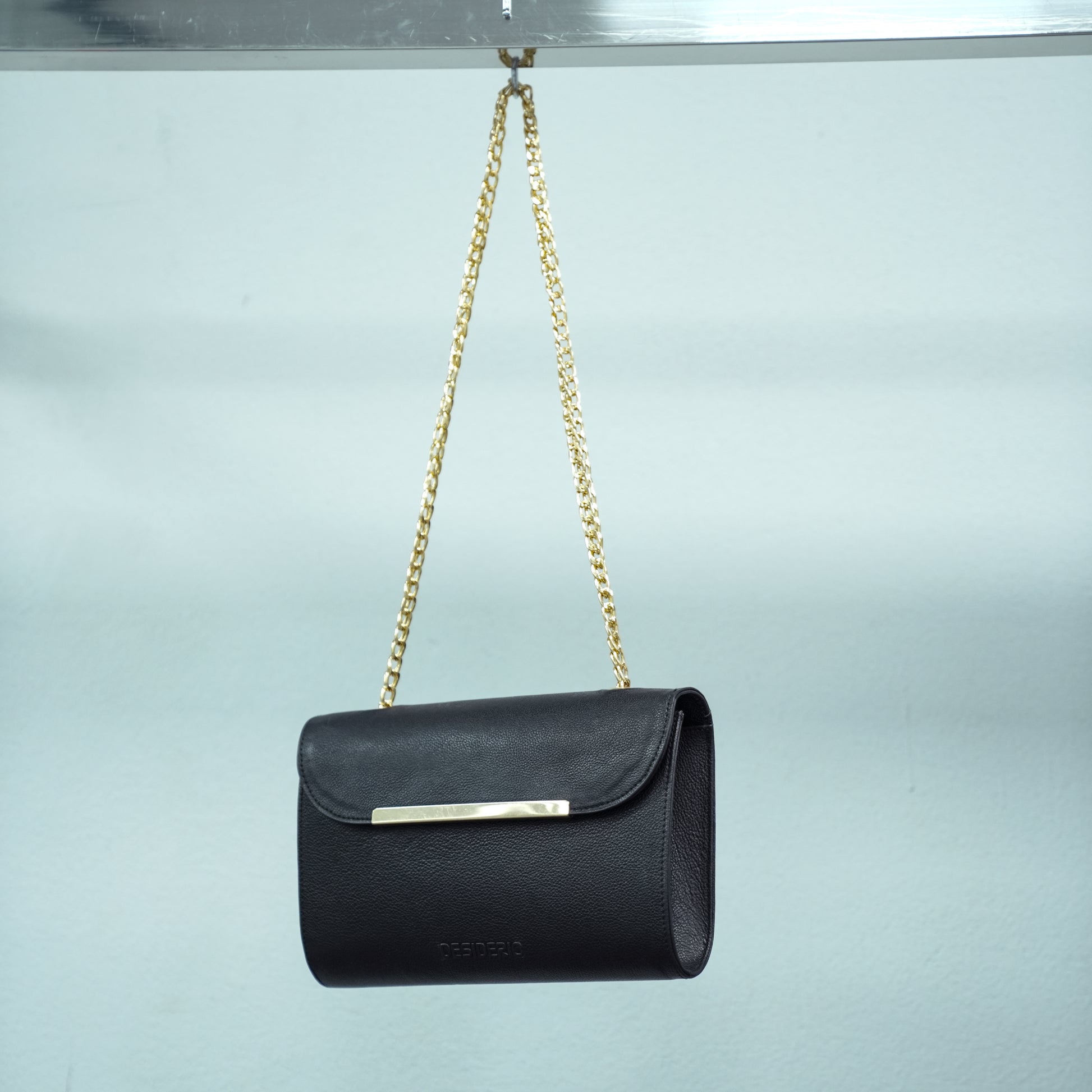 Classic black leather crossbody bag with long chain strap and two open pockets—stylish, durable, and perfect for both casual and formal occasions.