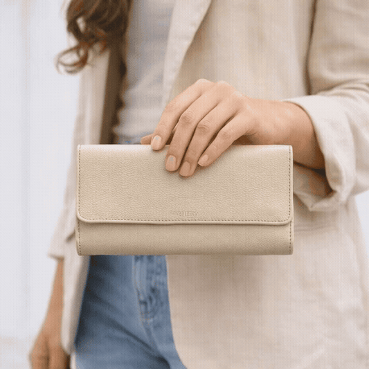 Beige leather clutch with two open pockets, one zip pocket, and eleven card slots