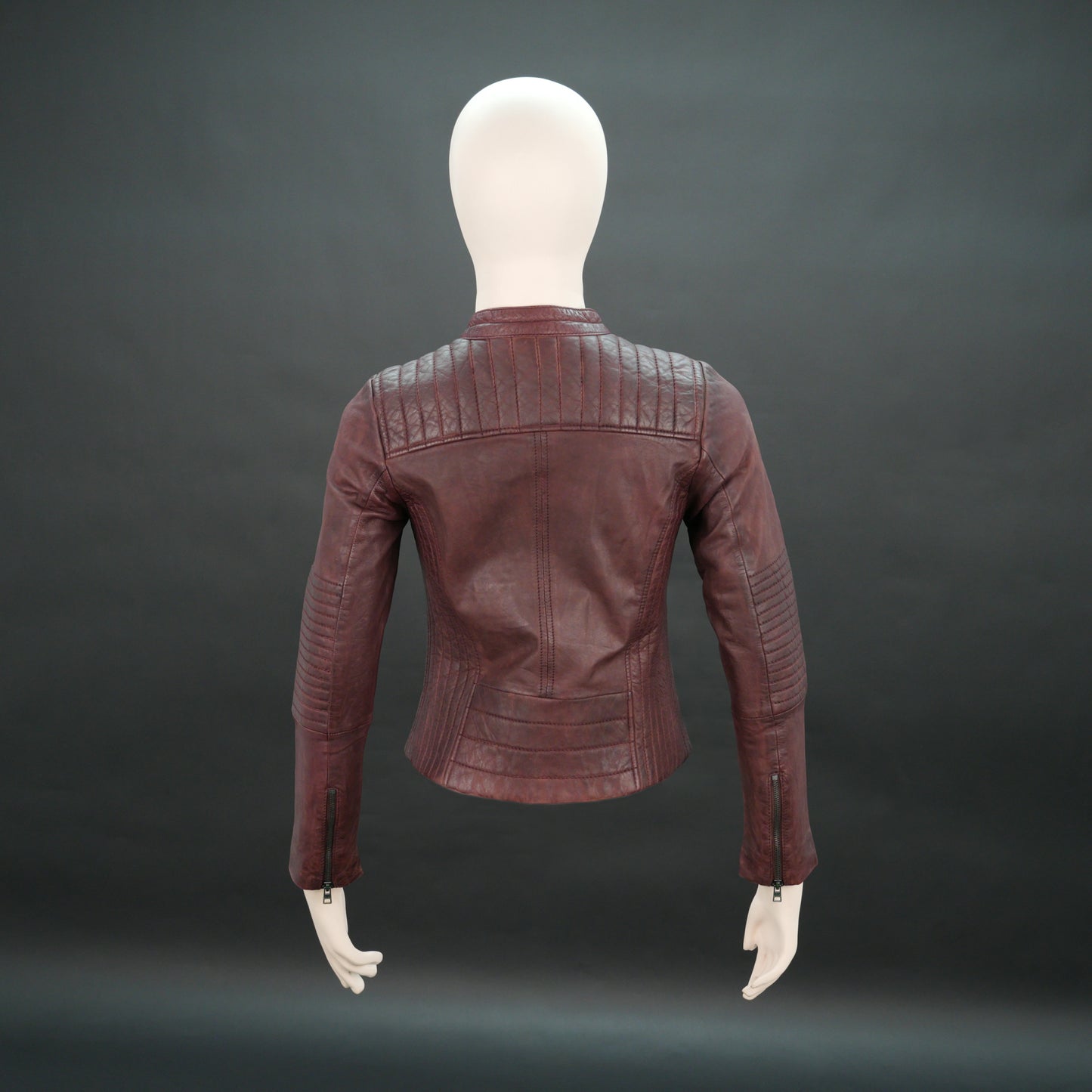 Women maroon leather biker jacket with quilted shoulders and front zip.