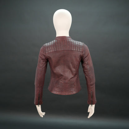 Women maroon leather biker jacket with quilted shoulders and front zip.