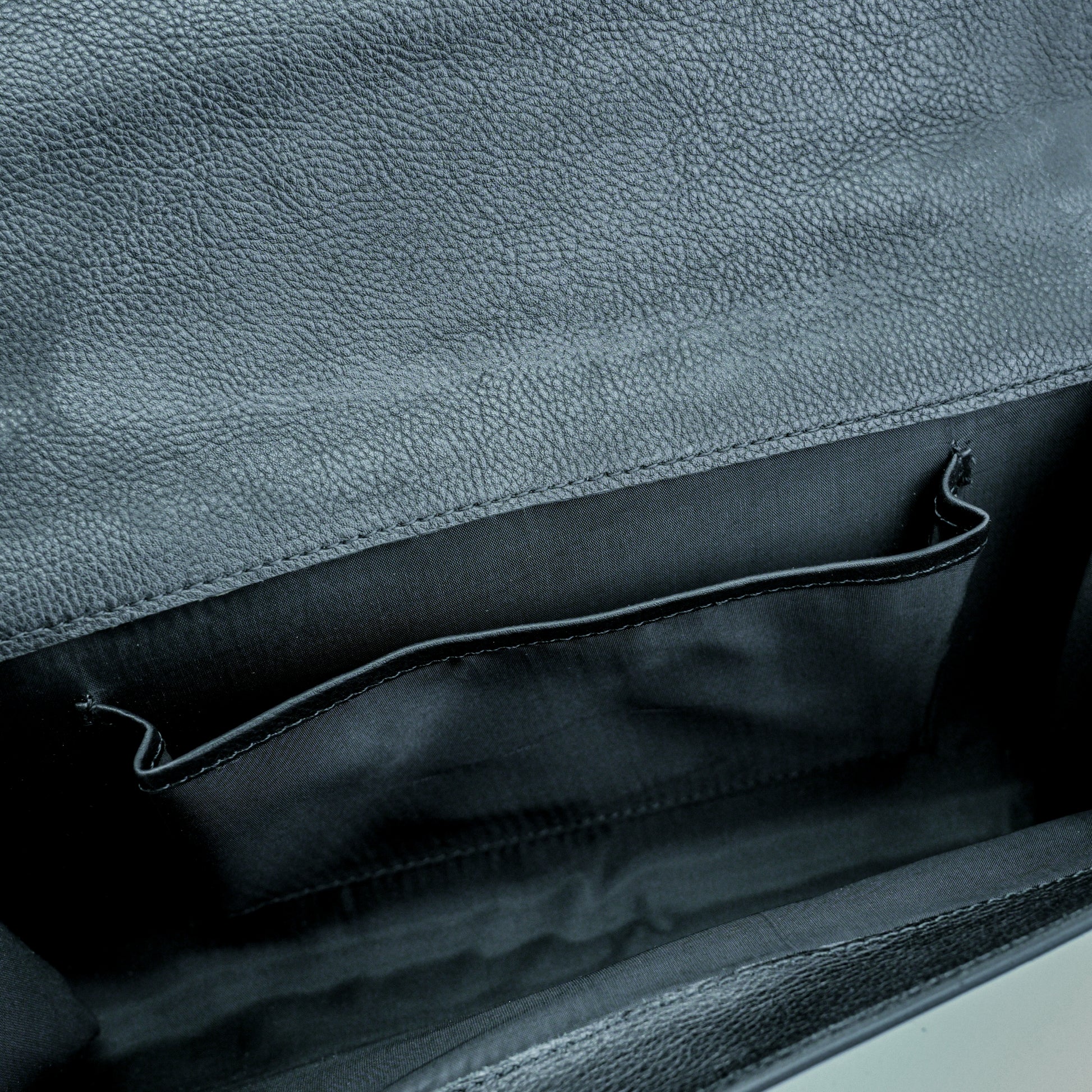 Leather grab handle bag with two open pockets, durable construction, and versatile design for everyday use