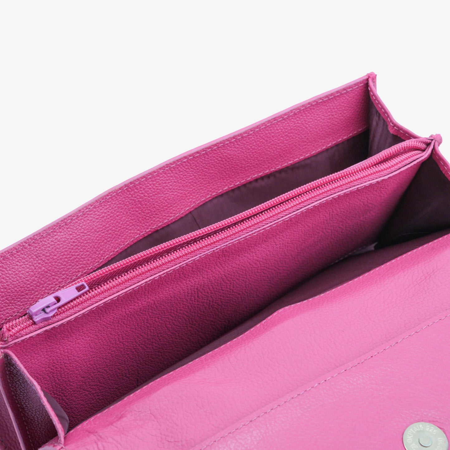 Pink leather clutch with three main compartments, one zip pocket, and three card pockets for organized storage