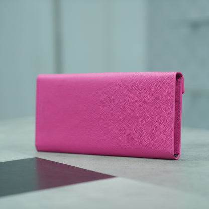 Pink leather clutch with three main compartments, one zip pocket, and three card pockets for organized storage