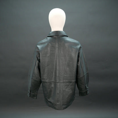 Black leather jacket with button closure, flap pockets, and relaxed fit.