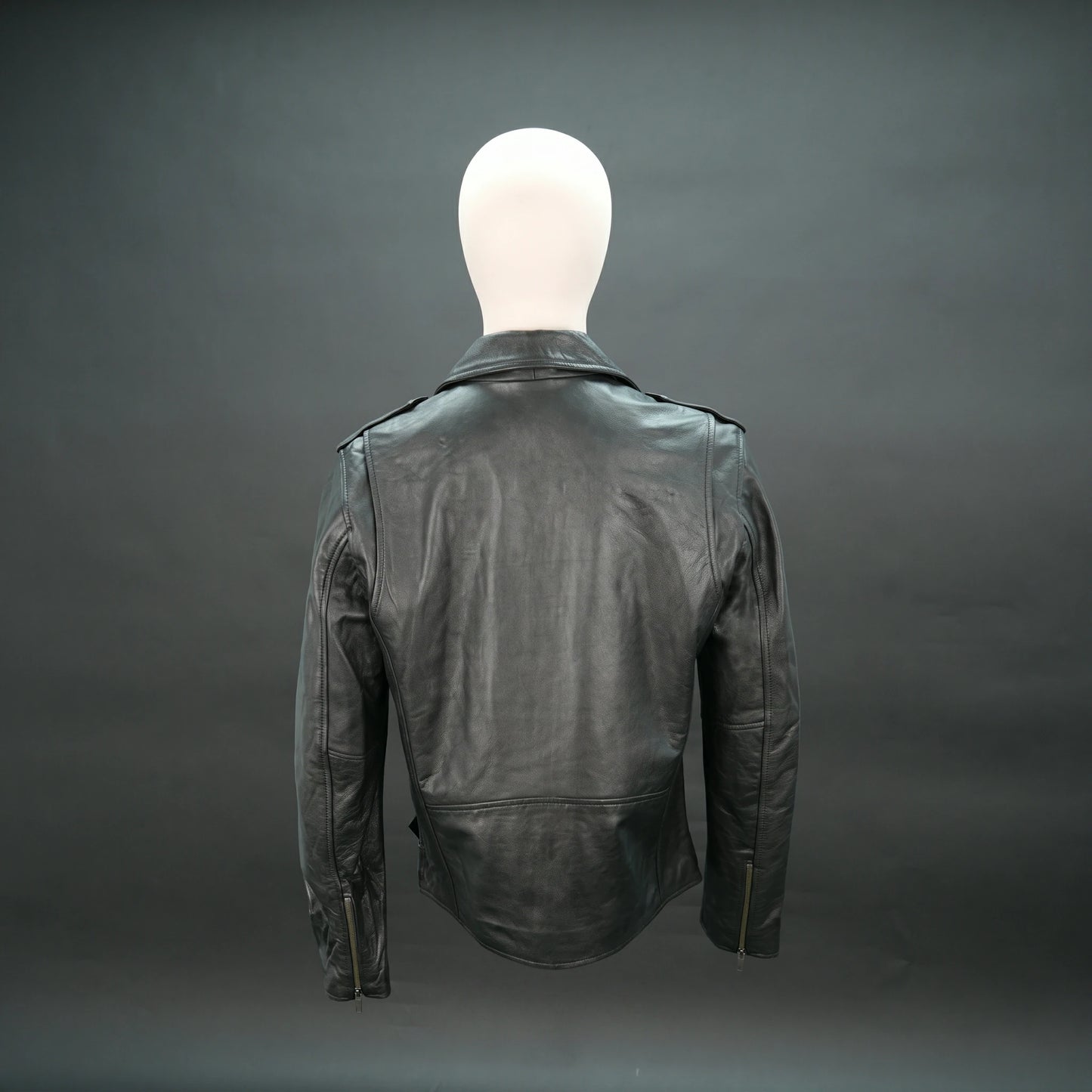 Black leather jacket with asymmetric zip, quilted details, and slim fit.