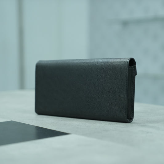 Black leather clutch with three compartments, sixteen card slots, a zip pocket, cash compartment, and key for security