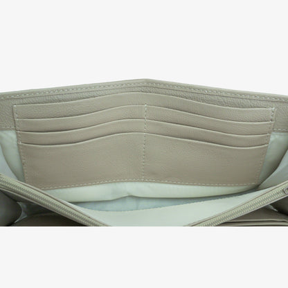 Beige leather clutch with three compartments, sixteen card slots, one zip pocket, cash compartment, and key for security