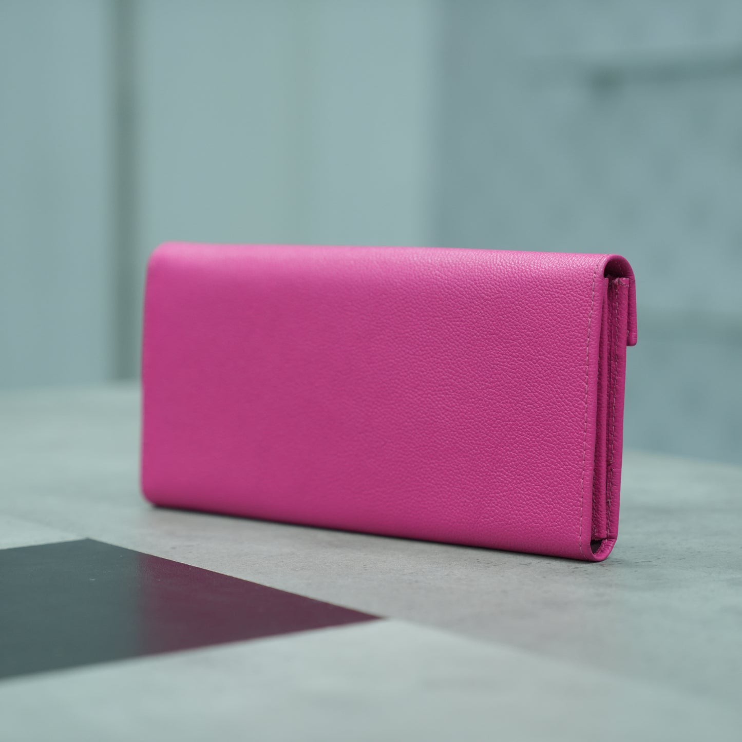 Pink leather clutch with three compartments, sixteen card slots, a zip pocket, cash compartment, and key for security