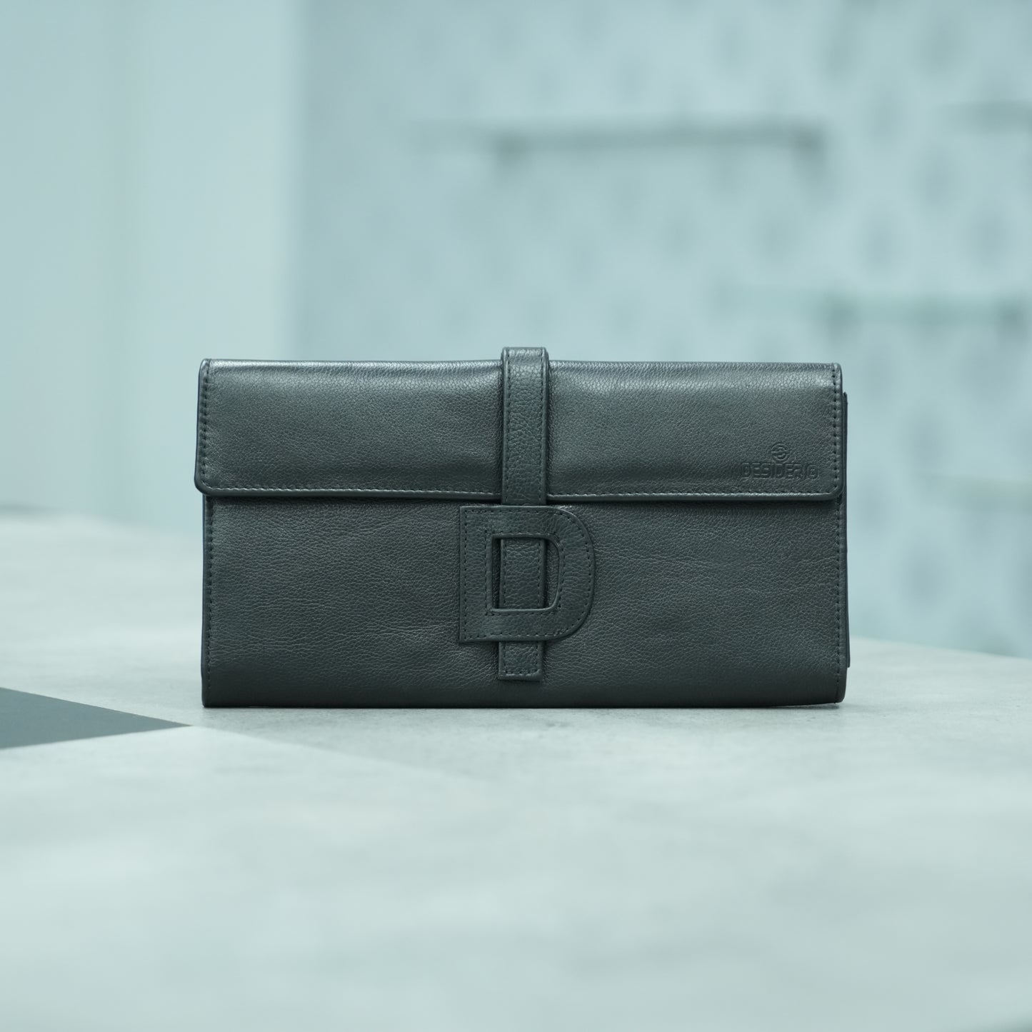 Black leather mini clutch with three compartments, sixteen card slots, and zip pocket, compact and elegant