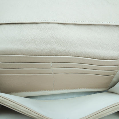Beige leather mini clutch with three compartments, sixteen card slots, and a zip pocket