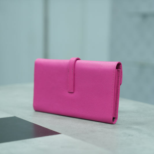 Compact pink leather mini clutch with three compartments, sixteen card slots, and zip pocket, combining sleek design with everyday functionality