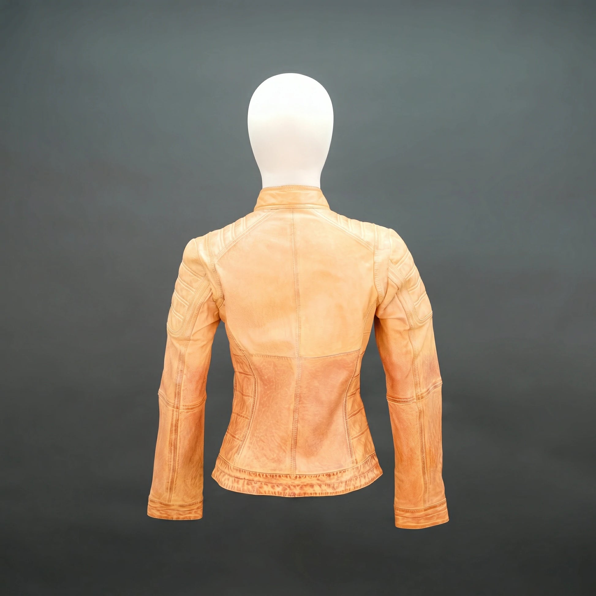 Tan distressed leather biker jacket with stand-up zip collar and quilted detailing.