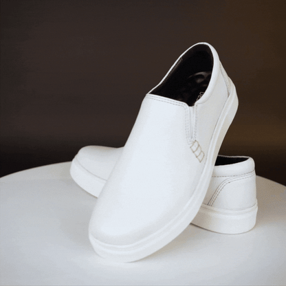 White slip-on sneakers crafted from premium Cow Chelsia leather with soft sheep leather lining, non-woven insole, and durable TPR sole—comfortable, flexible, and suitable for both formal and casual occasions.