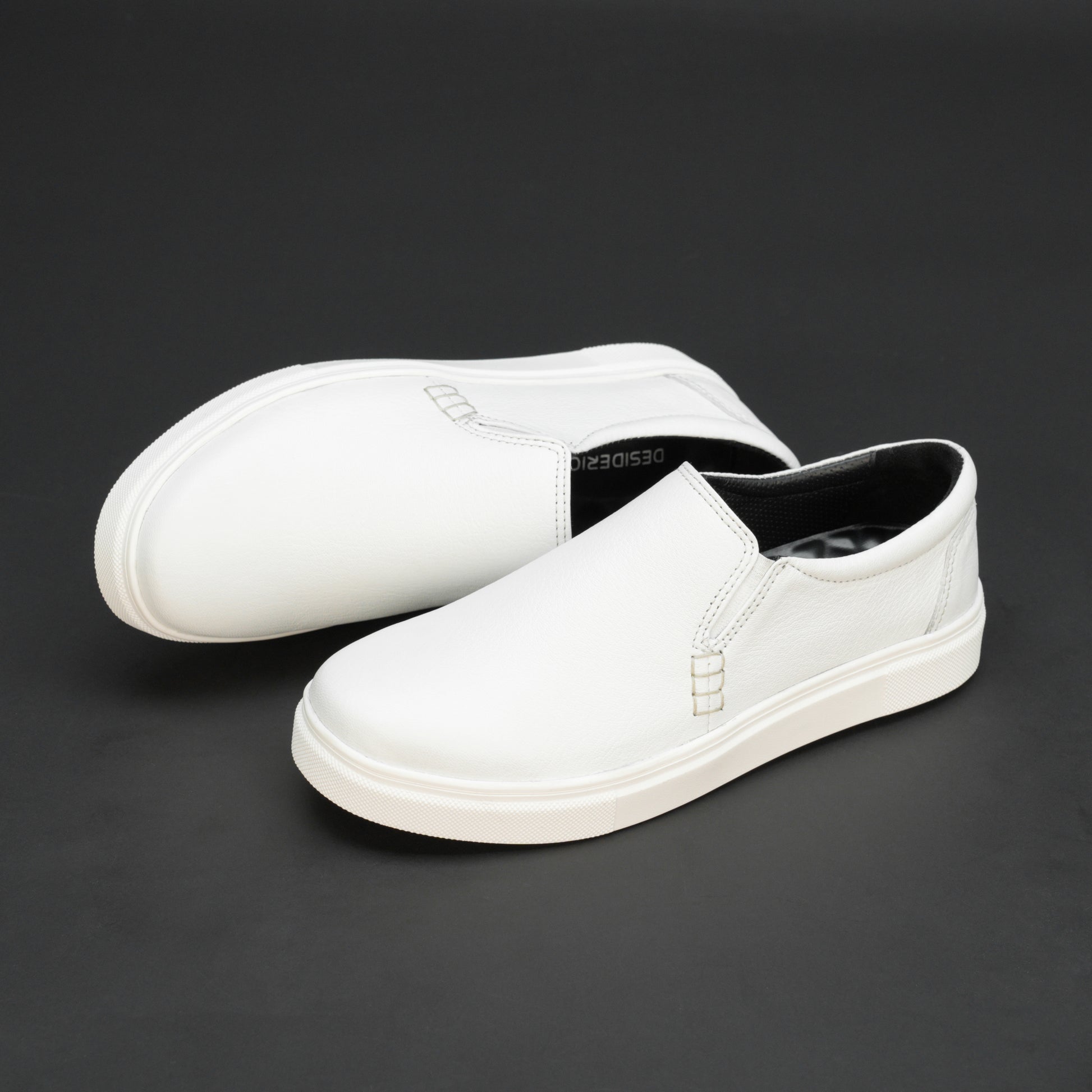 White slip-on sneakers crafted from premium Cow Chelsia leather with soft sheep leather lining, non-woven insole, and durable TPR sole—comfortable, flexible, and suitable for both formal and casual occasions.